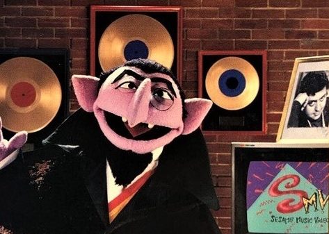 The Count and his wall of solid gold records.