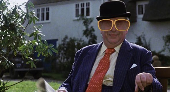 Robert Morley in big, 1970s sunglasses as the disco version of the Man on the Bench.
