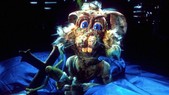 Harry the Hare from 'Meet the Feebles', falling to pieces and holding some sort of crucifix.