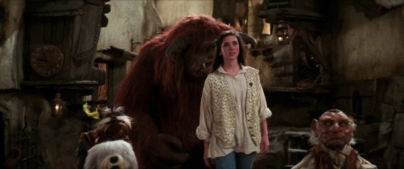 Screenshot from Labyrinth: Sarah and her friends approach the castle as Hoggle utters the words, "Piece of cake."