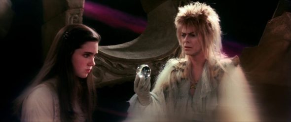 Screenshot from Labyrinth: A weary Jareth holds out his crystal ball one last time and begs Sarah to let him rule her as she recalls the line from her play.