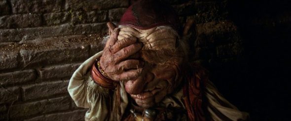 Screenshot from Labyrinth: Hoggle facepalms after Sarah tells Jareth the labyrinth is a piece of cake.