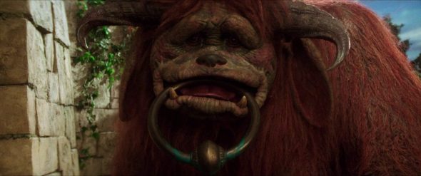 Screenshot from Labyrinth: Ludo holding a door knocker handle in his mouth.