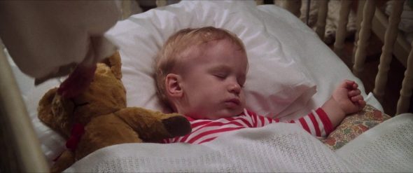 Screenshot from Labyrinth: Sarah gives Lancelot the teddy bear to Toby.