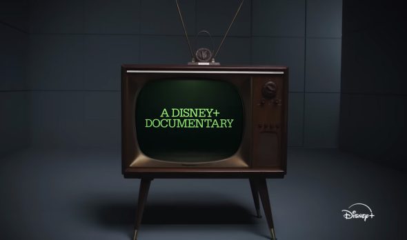 Screenshot from the 'Jim Henson: Idea Man' trailer: a TV set displays the words "A Disney Plus Documentary".