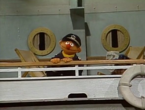 Ernie stands on the deck of a crusie ship