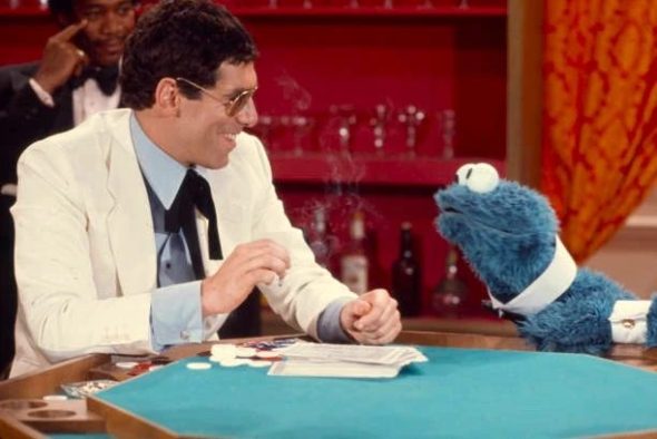 Elliot Gould and Cookie Monster playing cards in ' Out to Lunch'.