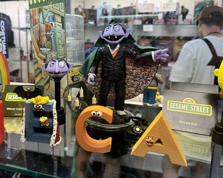 Photo of The Count's NECA action figure, which comes with an alternate head, a bat, a candelabra, and a telephone.