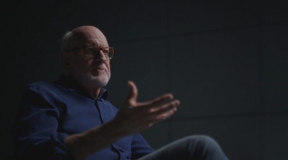 Frank Oz being interviewed for 'Idea Man' on the dark, gray, shadowy Cube-inspired set.