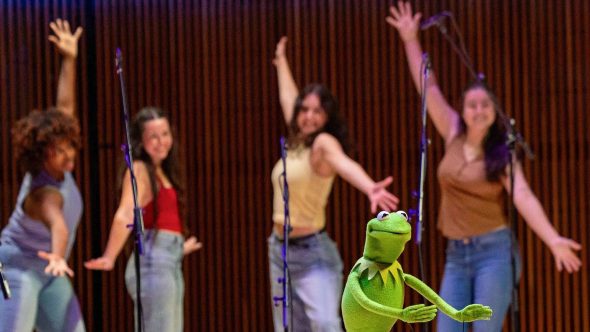 Kermit performing in front of UMD college student backup dancers.